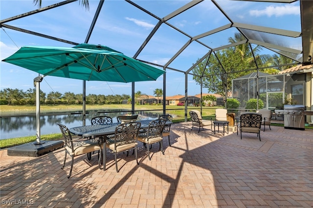 view of patio / terrace featuring a lanai, a grill, and a water view