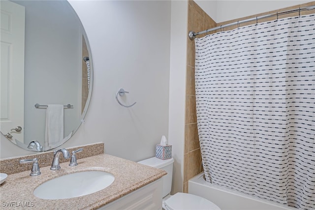 full bathroom featuring tiled shower / bath, vanity, and toilet