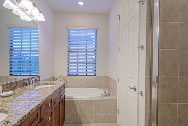 bathroom with vanity and independent shower and bath