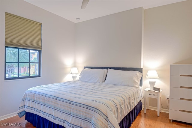 bedroom with ceiling fan and hardwood / wood-style floors