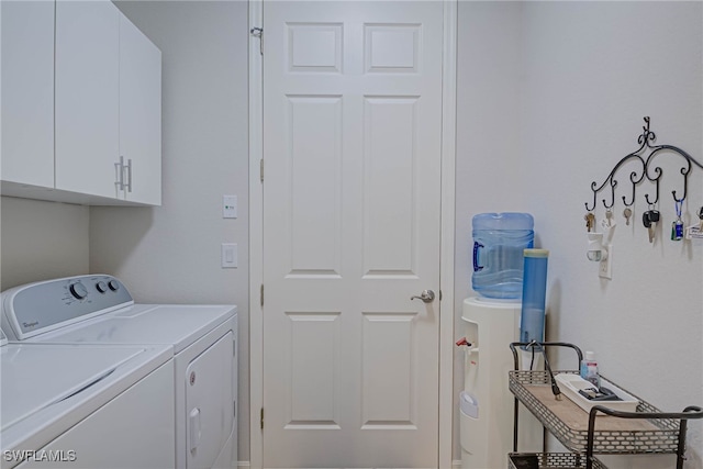 washroom featuring cabinets and independent washer and dryer