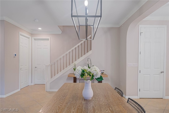 unfurnished dining area featuring crown molding and light tile patterned floors