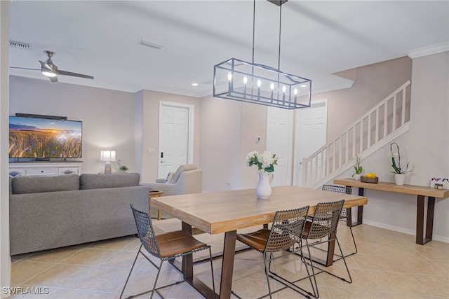 tiled dining room with ceiling fan and ornamental molding