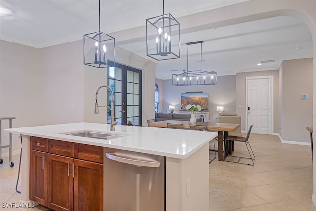 kitchen featuring pendant lighting, french doors, a center island with sink, sink, and stainless steel dishwasher