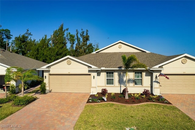 ranch-style home with a front yard and a garage