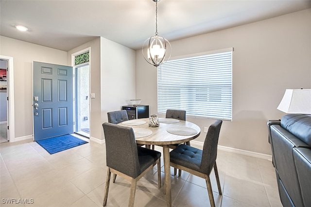 dining area with a notable chandelier and light tile patterned floors