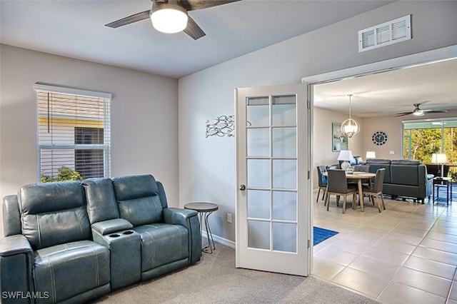 living room featuring ceiling fan, light tile patterned flooring, and french doors