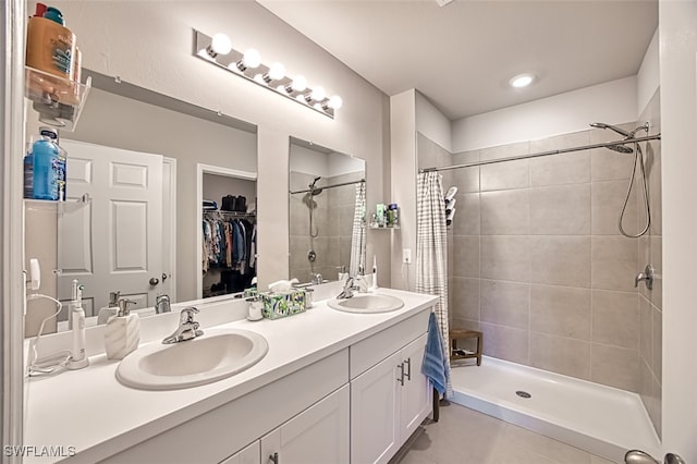 bathroom featuring tile patterned flooring, a shower with curtain, and vanity