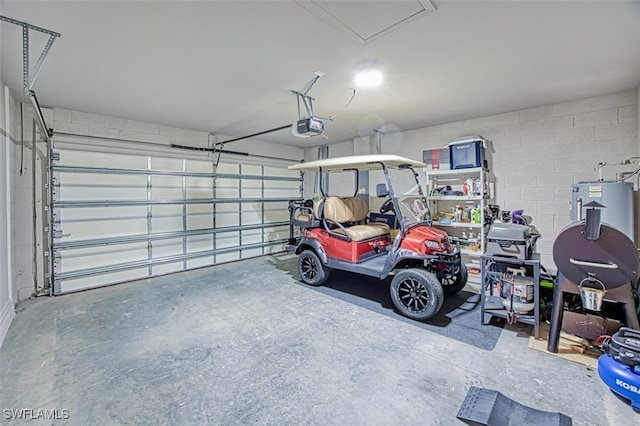 garage featuring electric water heater and a garage door opener