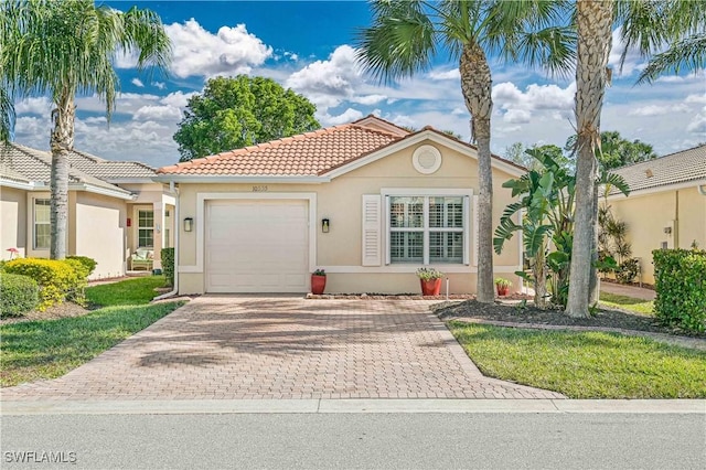 mediterranean / spanish home with a garage