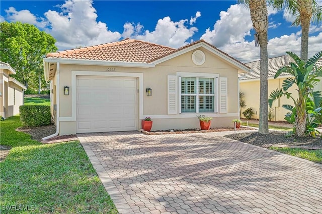 mediterranean / spanish-style house with a garage