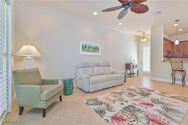 tiled living room featuring ceiling fan