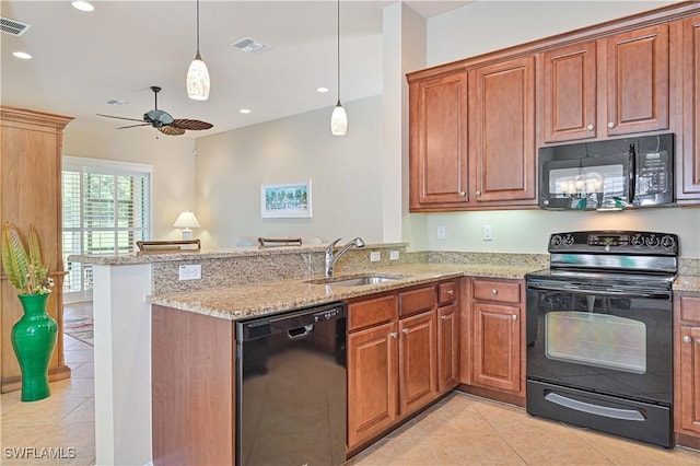 kitchen with kitchen peninsula, light stone counters, sink, and black appliances