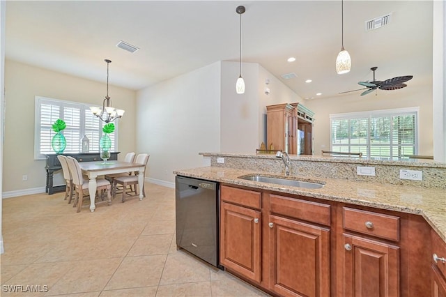 kitchen with light stone counters, stainless steel dishwasher, ceiling fan with notable chandelier, sink, and hanging light fixtures