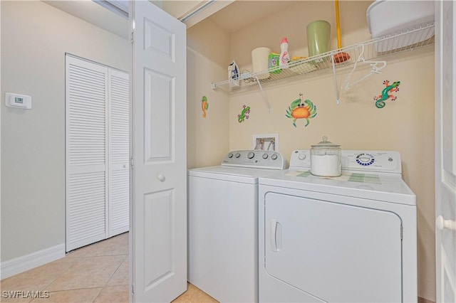 laundry room with light tile patterned floors and independent washer and dryer