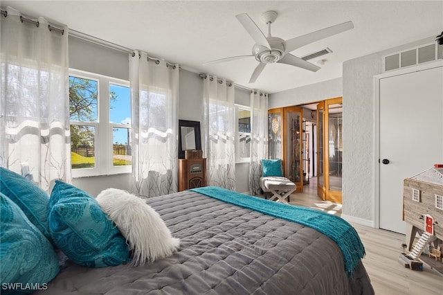 bedroom featuring hardwood / wood-style floors, a closet, and ceiling fan