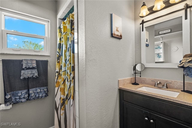 bathroom with a shower with curtain and vanity