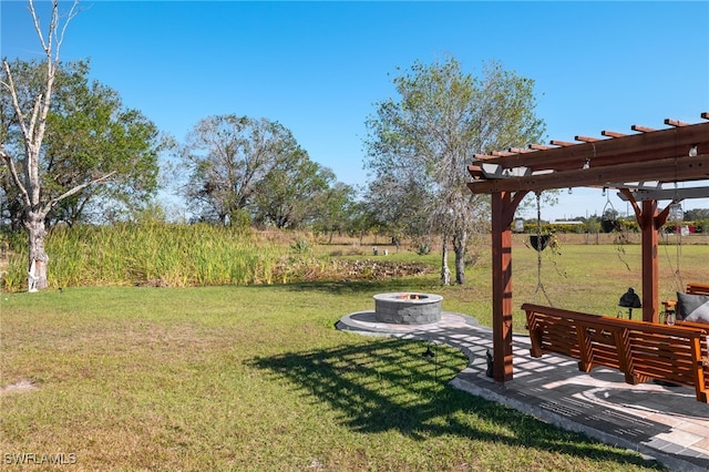 view of yard featuring a fire pit and a pergola