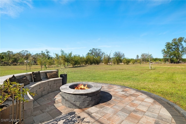 view of patio with a rural view and an outdoor fire pit