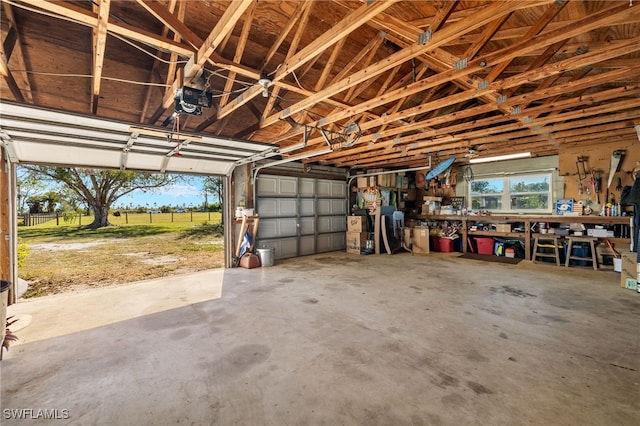 garage with a workshop area and a garage door opener