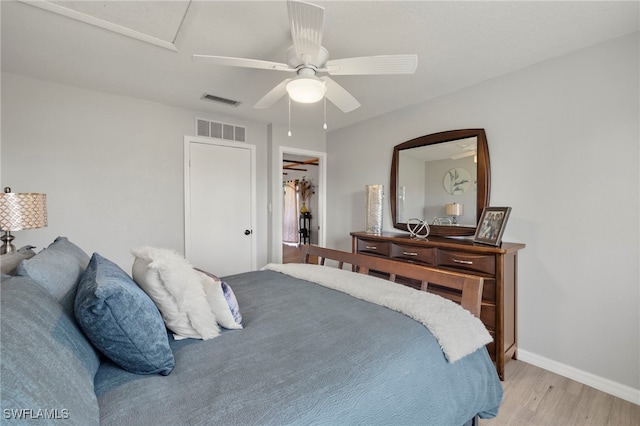 bedroom featuring ceiling fan, a closet, and light wood-type flooring