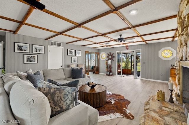 living room featuring beamed ceiling, ceiling fan, light hardwood / wood-style floors, and coffered ceiling