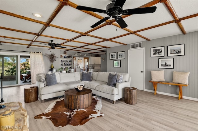 living room featuring beamed ceiling, light hardwood / wood-style flooring, and coffered ceiling