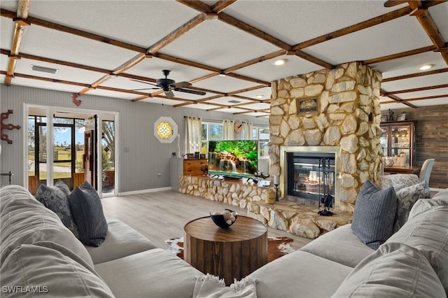 living room with a fireplace, a wealth of natural light, ceiling fan, and coffered ceiling