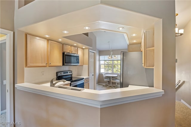 kitchen with appliances with stainless steel finishes, tasteful backsplash, an inviting chandelier, and light brown cabinetry