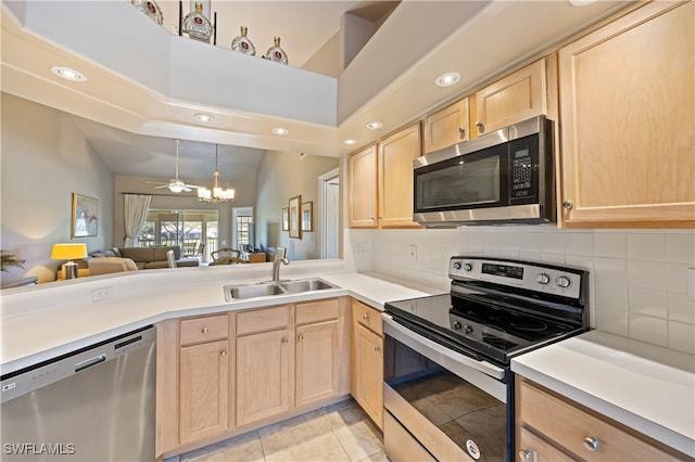 kitchen with sink, decorative backsplash, light brown cabinetry, light tile patterned flooring, and stainless steel appliances