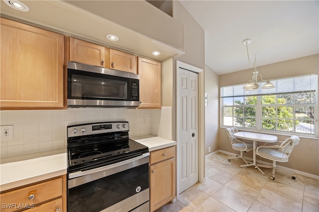 kitchen with light brown cabinets, backsplash, vaulted ceiling, decorative light fixtures, and stainless steel appliances