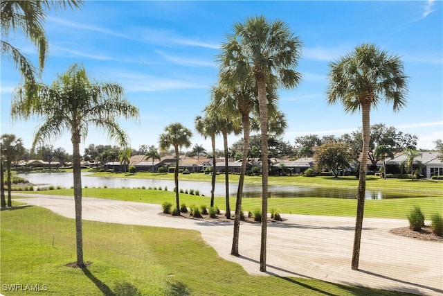 view of property's community featuring a yard and a water view