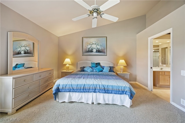 carpeted bedroom with connected bathroom, vaulted ceiling, and ceiling fan