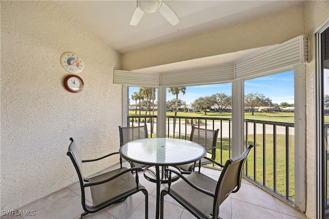 sunroom featuring ceiling fan and vaulted ceiling