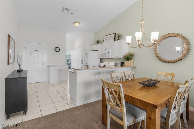 tiled dining area featuring vaulted ceiling and a notable chandelier