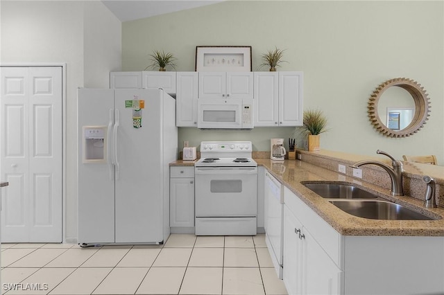 kitchen with white cabinetry, sink, light stone counters, white appliances, and light tile patterned floors