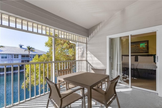 sunroom / solarium with a water view