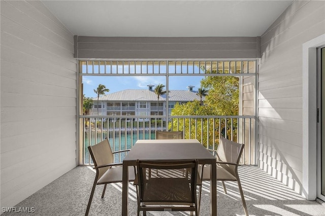 sunroom / solarium featuring a water view