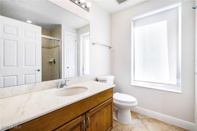 bathroom featuring vanity, toilet, and walk in shower