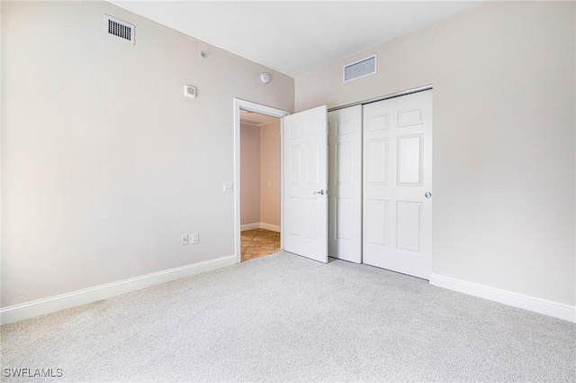 unfurnished bedroom featuring carpet floors and a closet