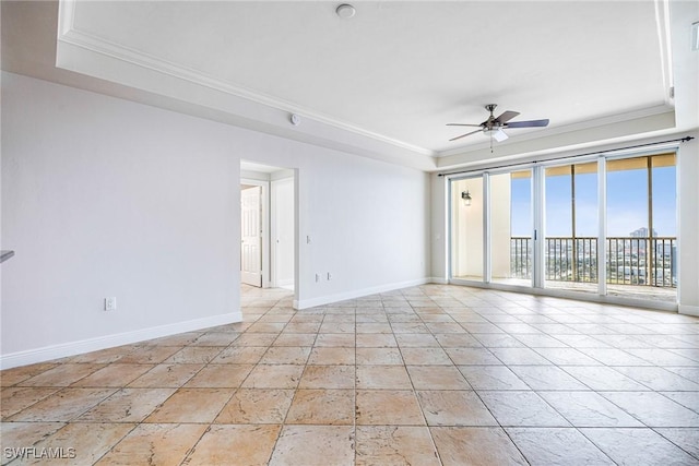 unfurnished room with a raised ceiling, ceiling fan, and ornamental molding