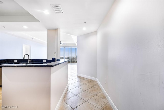 kitchen with light tile patterned floors and sink