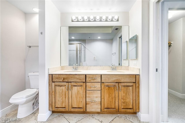 bathroom featuring an enclosed shower, vanity, and toilet