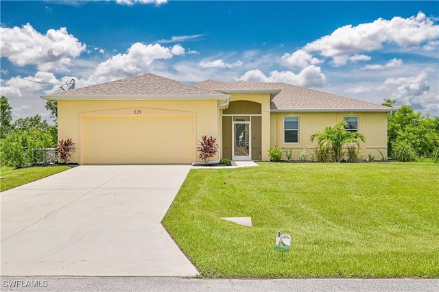 view of front of home featuring a front yard and a garage