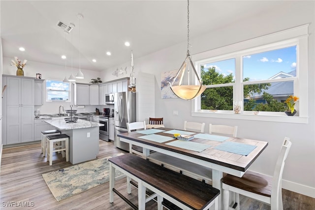 dining area featuring light hardwood / wood-style flooring and sink