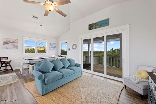 living room with hardwood / wood-style floors, ceiling fan, and vaulted ceiling