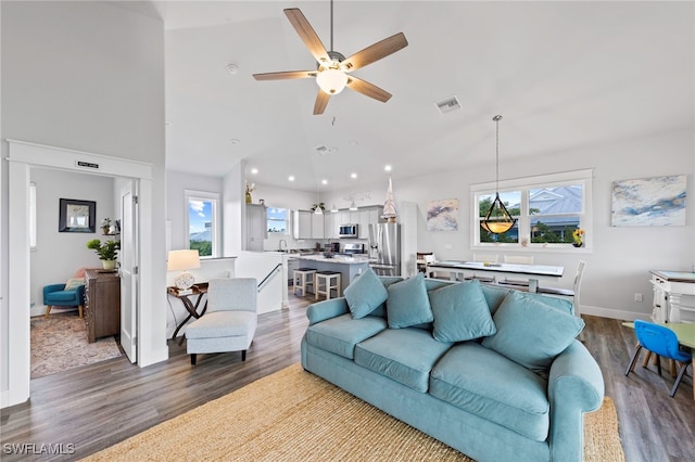 living room with ceiling fan, plenty of natural light, sink, and hardwood / wood-style flooring