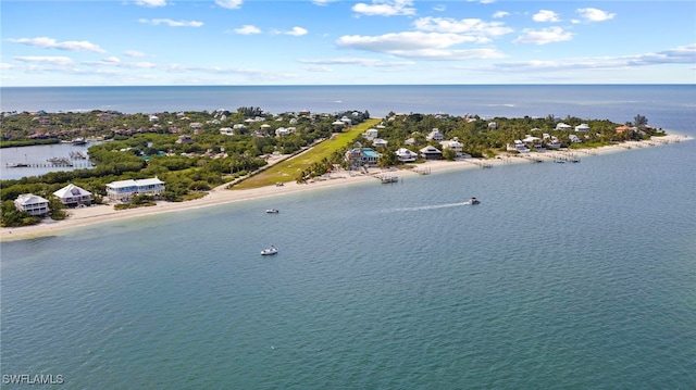 drone / aerial view featuring a beach view and a water view