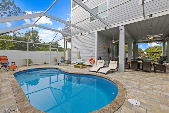 view of pool featuring a lanai, ceiling fan, and a patio area