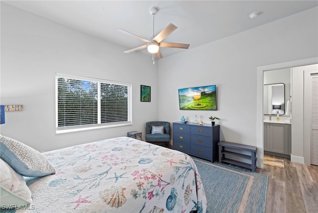 bedroom featuring connected bathroom, dark hardwood / wood-style floors, and ceiling fan